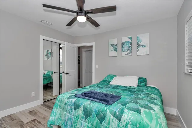 a bedroom with a large bed and a chandelier