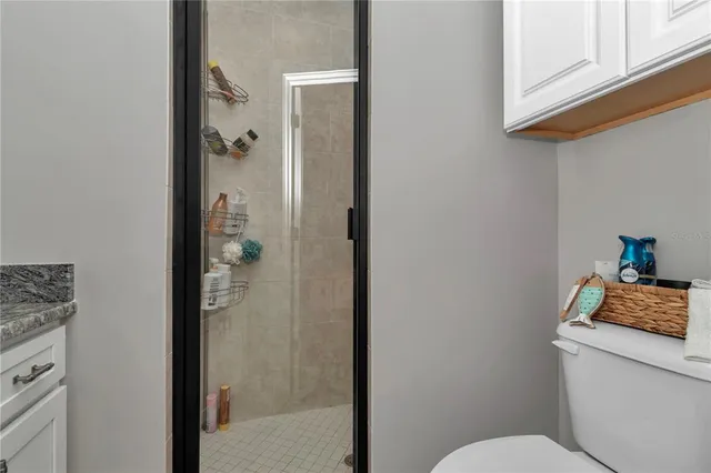 a bathroom with a toilet and a shower