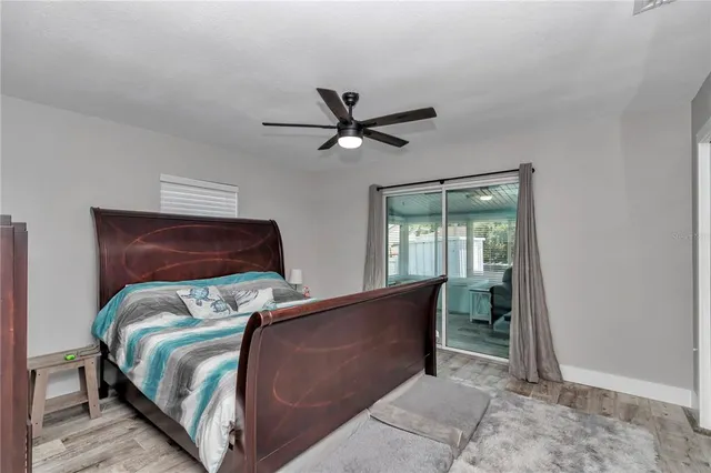 a bed sitting in a bedroom next to a window