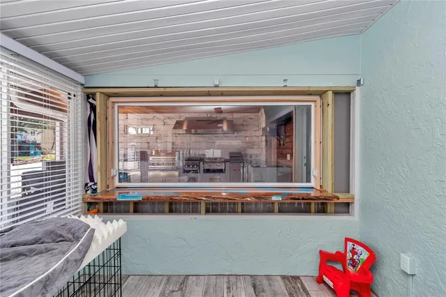 a view of a living room with furniture and a large window