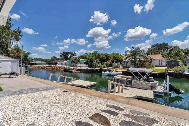 a view of a patio with a dining table and chairs with wooden floor