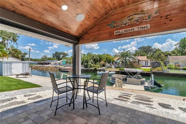 a porch with a table and chairs