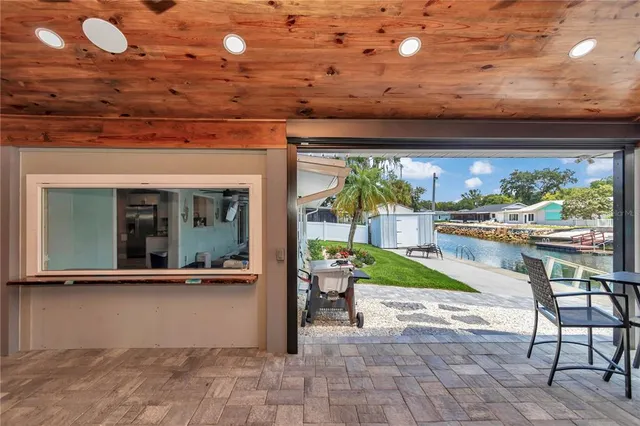 a kitchen with table chairs stainless steel appliances and cabinets