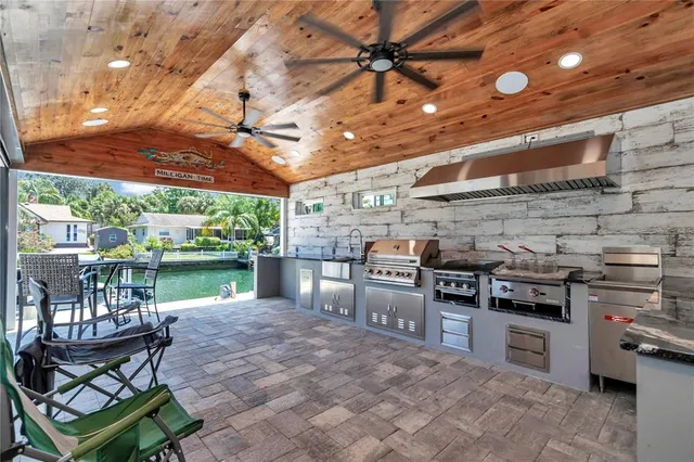 a large kitchen with stainless steel appliances and a stove top oven