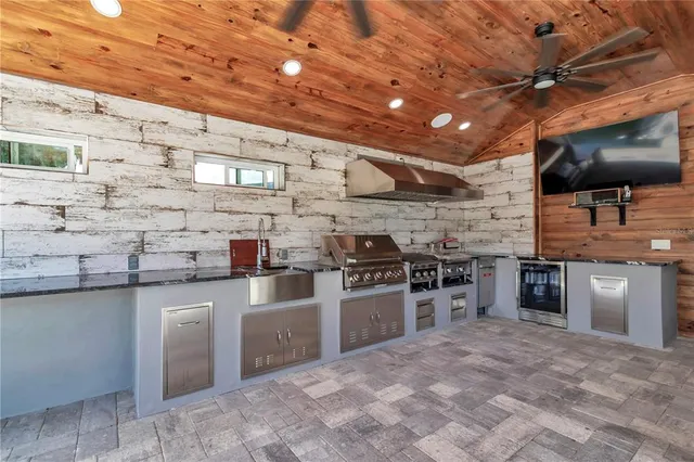a kitchen with stainless steel appliances granite countertop a stove and a sink