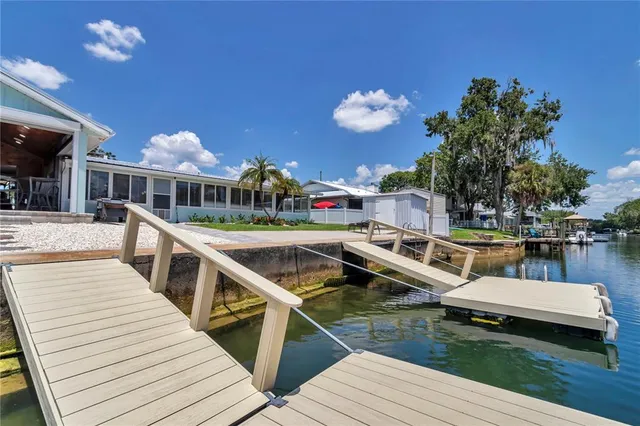 a view of swimming pool with outdoor seating and lake view