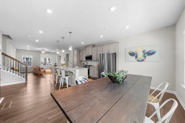 a living room with lots of furniture and kitchen view