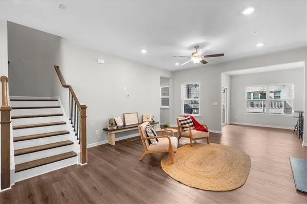 a living room with furniture and wooden floor