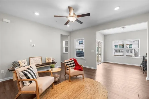 a living room with furniture and a wooden floor
