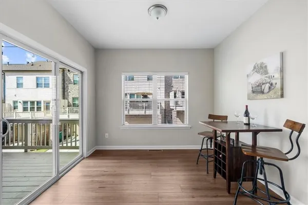 a view of a dining room with furniture window and wooden floor