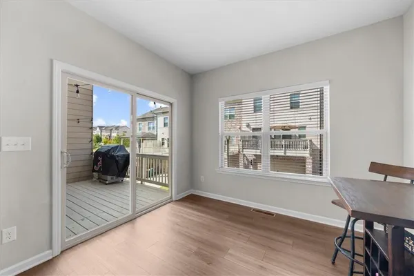 a view of a livingroom with wooden floor and furniture