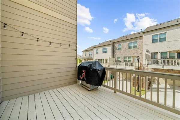 a view of a deck with wooden floor and iron fence