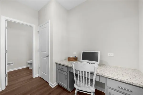a room with wooden floor and white walls