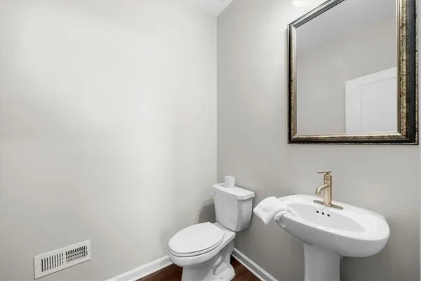 a bathroom with a sink a mirror and a toilet