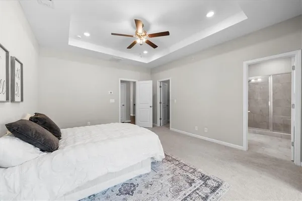 a bedroom with a large bed and a chandelier