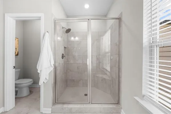 a bathroom with a shower and a toilet