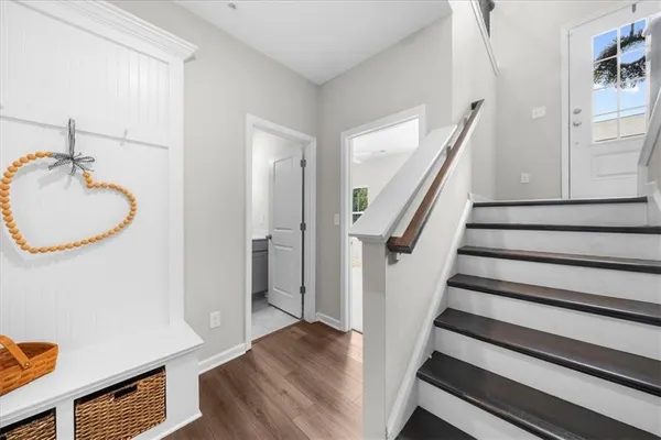 a view of a room with wooden floor and staircase