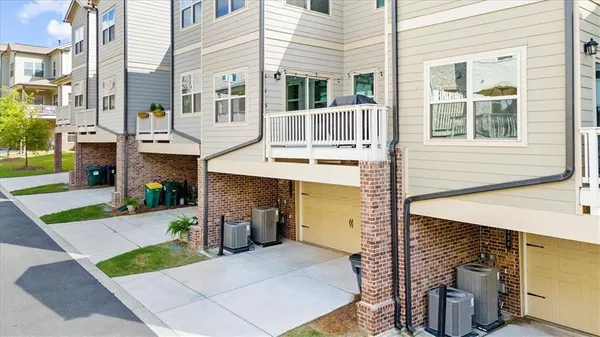 a front view of a house with a garden and plants