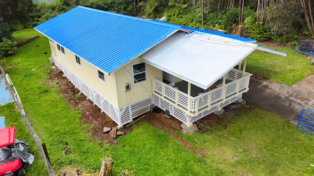 a aerial view of a house with a yard