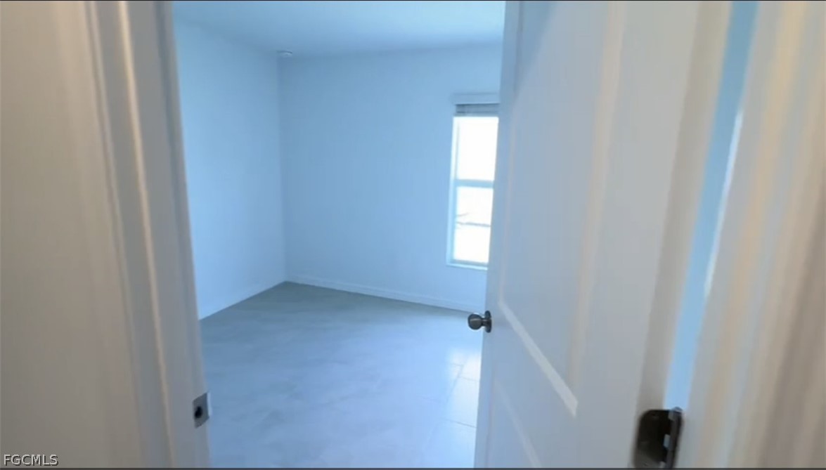 12312 Amber Waves Road Lehigh Acres, FL 33974 - Photo 9 of 33 a view of empty room with window