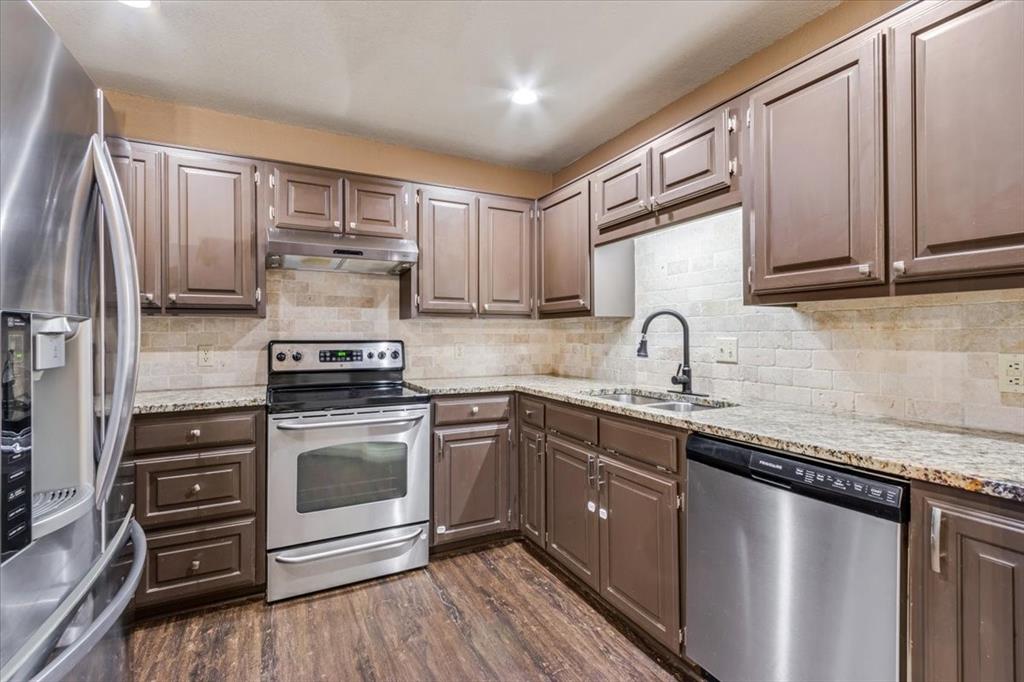 9508 Riviera Drive Waco, TX 76712 - Photo 11 of 24 a kitchen with stainless steel appliances a sink cabinets and wooden floor