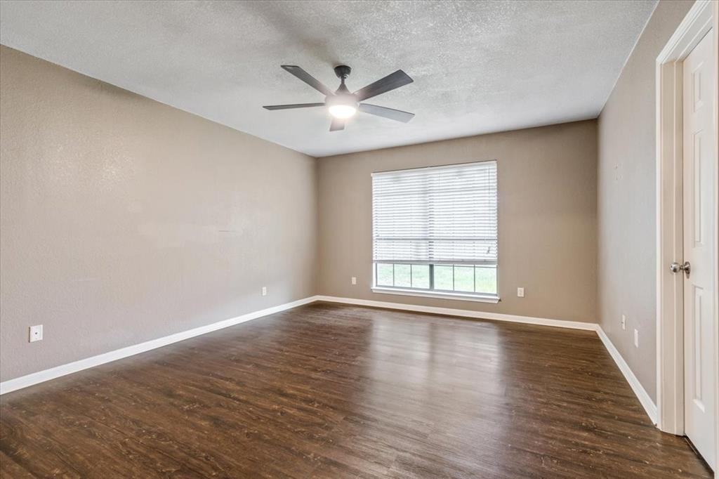 9508 Riviera Drive Waco, TX 76712 - Photo 14 of 24 a view of an empty room with wooden floor and a window