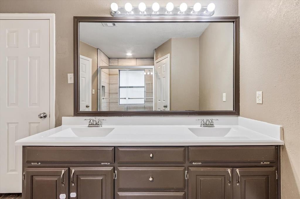 9508 Riviera Drive Waco, TX 76712 - Photo 16 of 24 a bathroom with a sink and a mirror