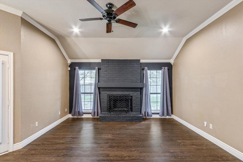 9508 Riviera Drive Waco, TX 76712 - Photo 7 of 24 a view of empty room with wooden floor and fireplace