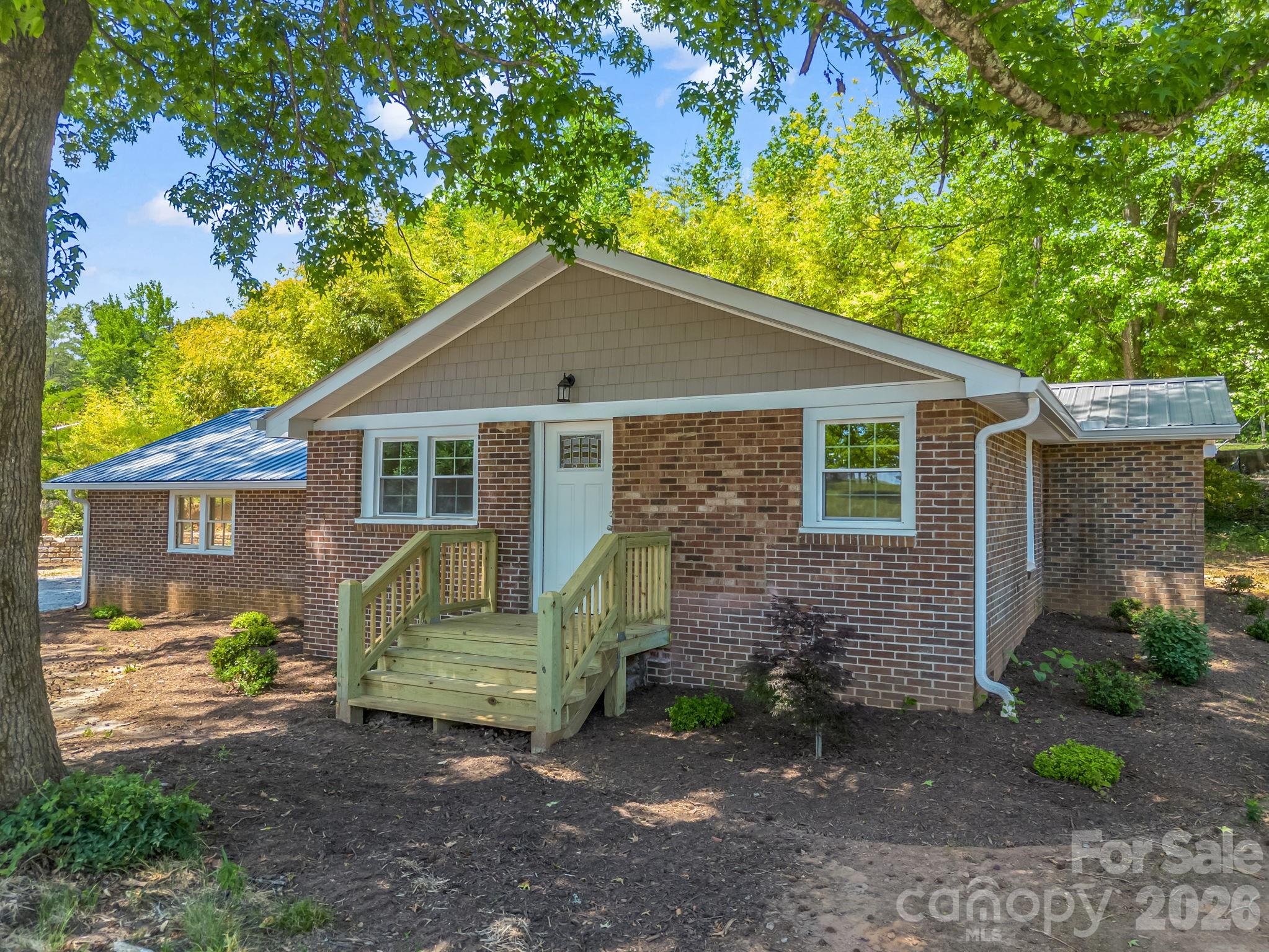 5923 Highway 14 Landrum, SC 29356 - Photo 3 of 15 a front view of a house with garden