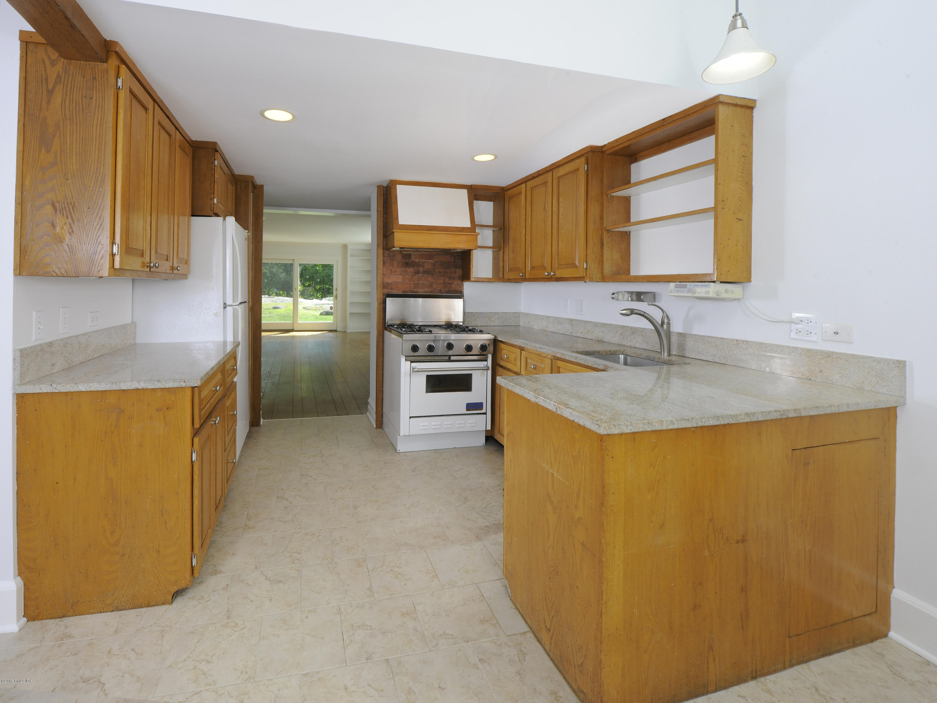 115 Doubling Road Greenwich, CT 06830 - Photo 7 of 10 a kitchen with kitchen island a sink appliances and cabinets