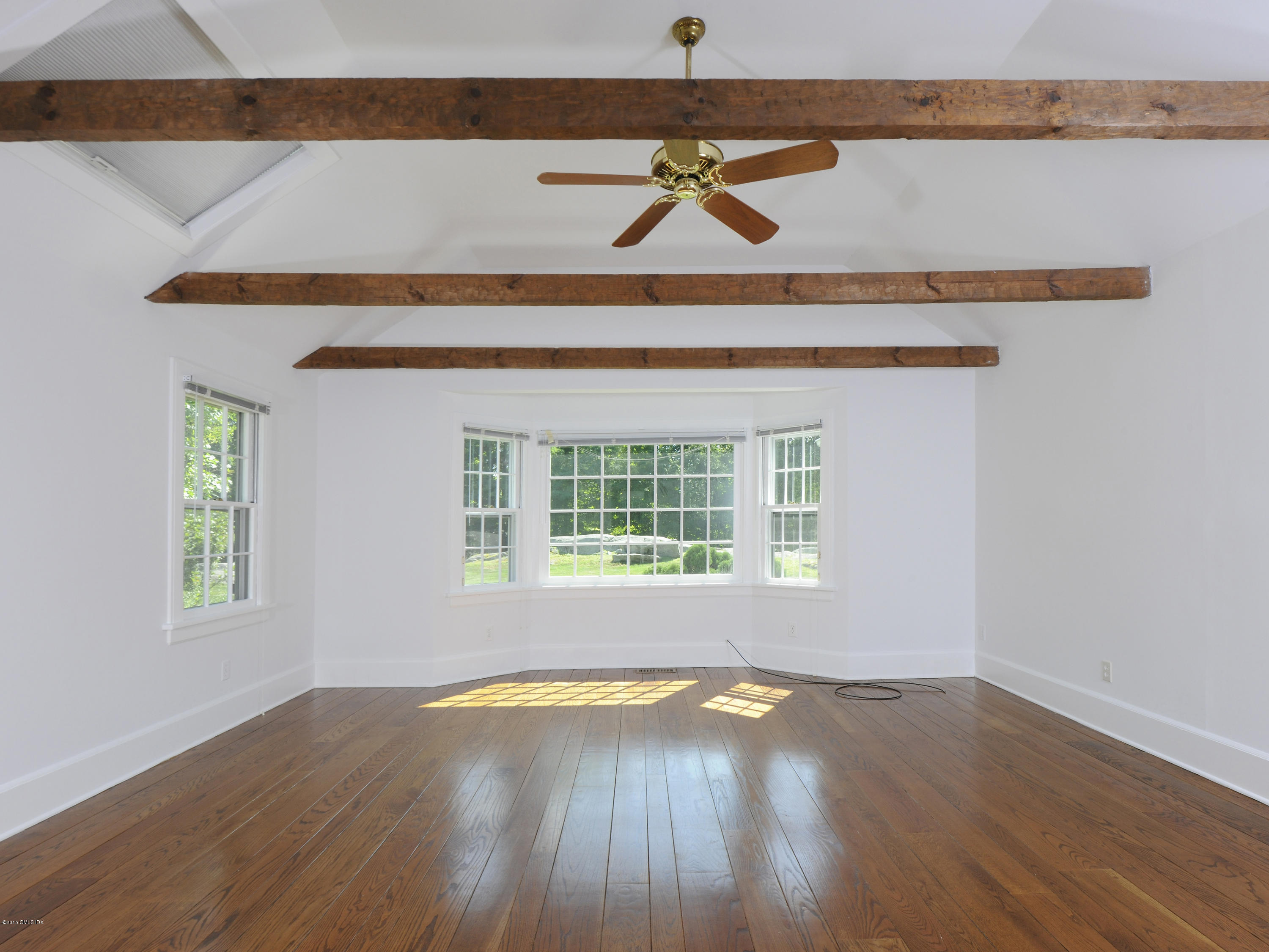 115 Doubling Road Greenwich, CT 06830 - Photo 8 of 10 a view of an empty room with wooden floor and a window