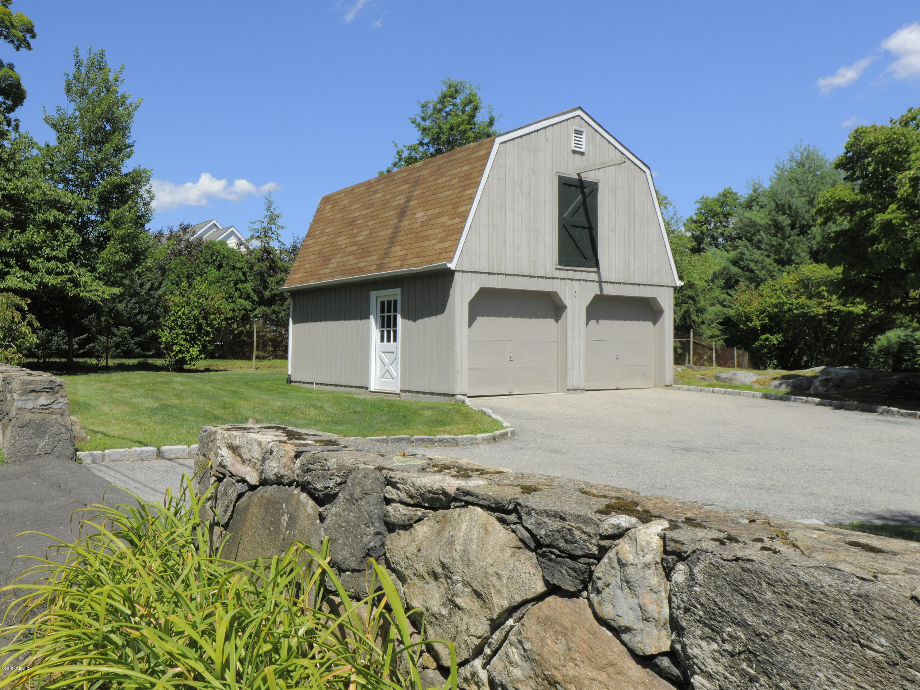 115 Doubling Road Greenwich, CT 06830 - Photo 10 of 10 a front view of a house with a yard