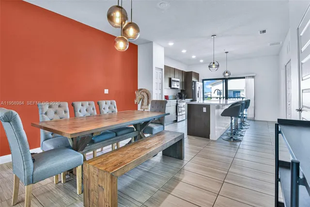 a large kitchen with a table and chairs