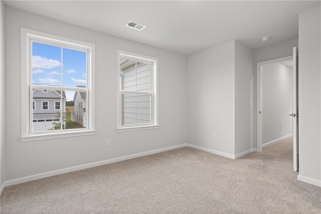 629 Sweetspire Trail, Unit 149 Seneca, SC 29678 - Photo 17 of 30 A quiet bedroom offering dual windows with views of the neighborhood, and plush carpeting.