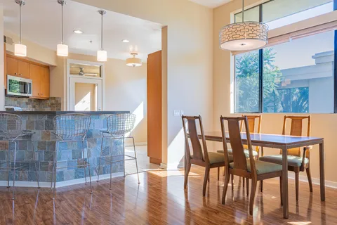 a view of a dining room with furniture and wooden floor