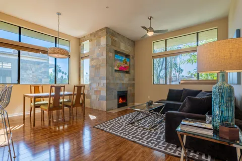 a living room with furniture fireplace and a window