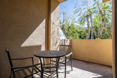 a view of a livingroom with furniture and a table in it