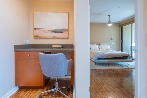 a bed sitting in a bedroom next to a window