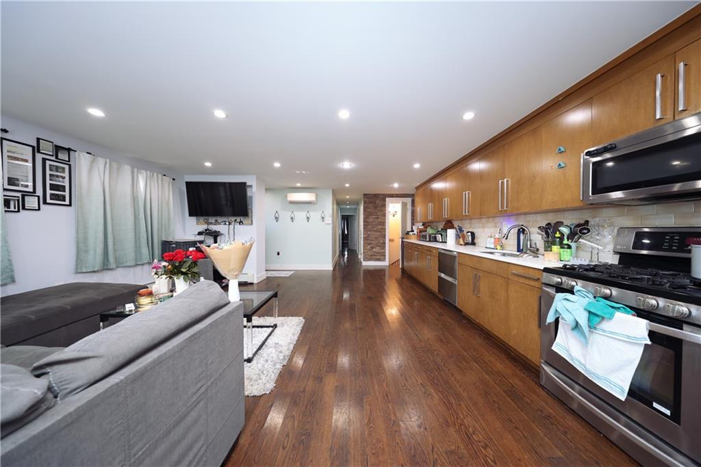 468 Ave Y Brooklyn, NY 11223 - Photo 24 of 47 a living room with stainless steel appliances furniture and a flat screen tv