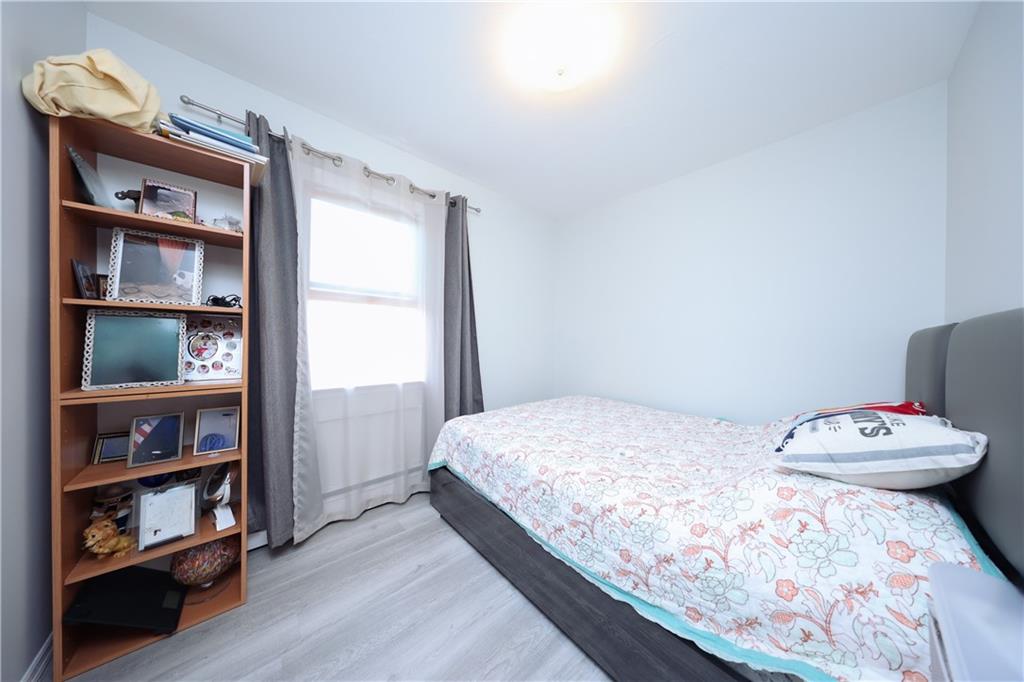 468 Ave Y Brooklyn, NY 11223 - Photo 27 of 47 a bedroom with a bed and a book shelf