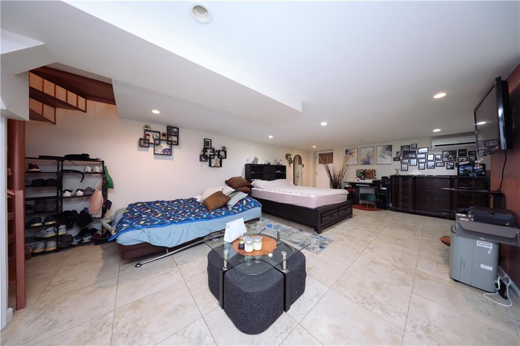 468 Ave Y Brooklyn, NY 11223 - Photo 30 of 47 a living room with furniture a rug and gym equipment