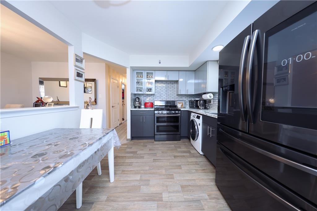 468 Ave Y Brooklyn, NY 11223 - Photo 43 of 47 a kitchen with stainless steel appliances granite countertop a stove top oven a sink and dishwasher