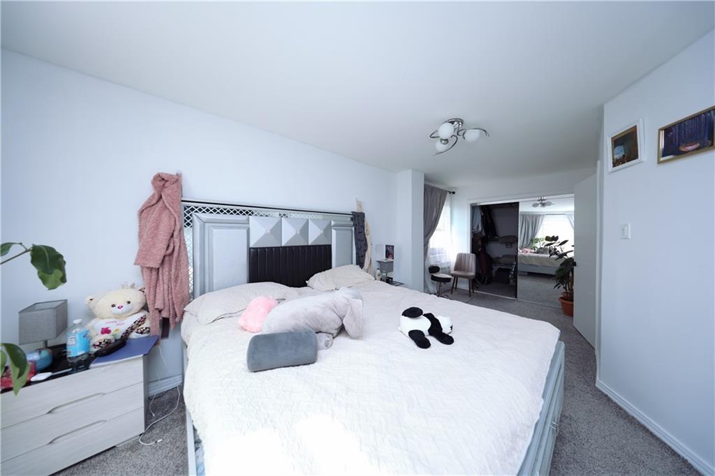 468 Ave Y Brooklyn, NY 11223 - Photo 45 of 47 a bedroom with a bed and a view of kitchen