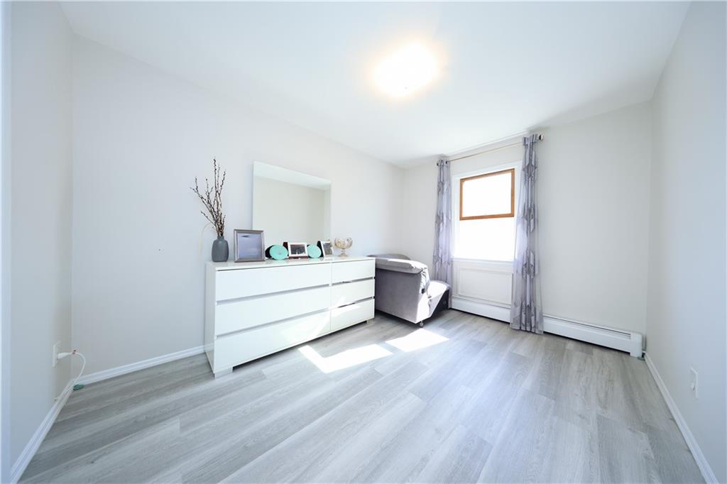 468 Ave Y Brooklyn, NY 11223 - Photo 46 of 47 a view of a room with wooden floor and window