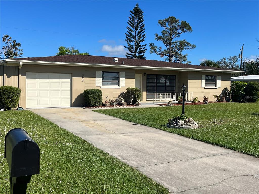 325 Glen Oak Road Venice, FL 34293 - Photo 1 of 1 a front view of a house with a yard and garage