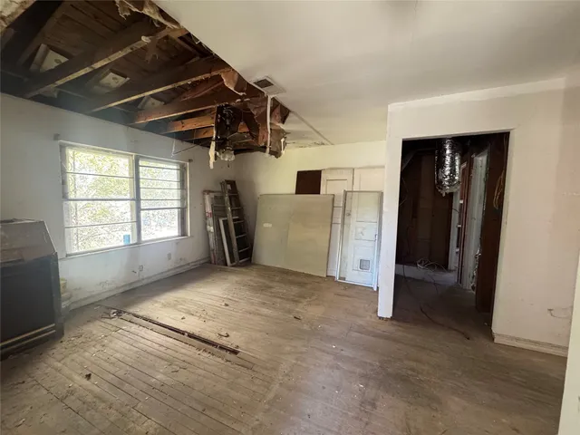 an empty room with windows and closet