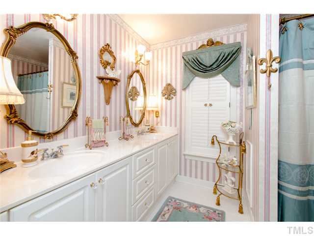 105 Carpathian Way Raleigh, NC 27615 - Photo 23 of 25 a bathroom with a sink and a mirror