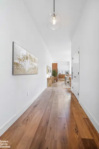 a view of kitchen and hall with wooden floor