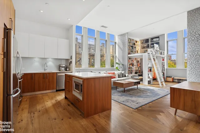 a kitchen with stainless steel appliances granite countertop a stove top oven a sink dishwasher and cabinets with wooden floor