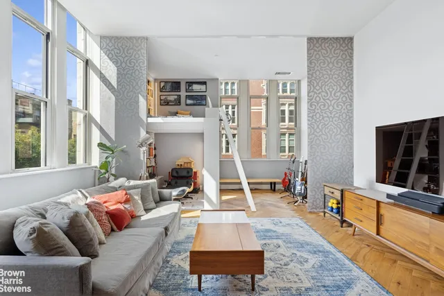 a living room with fireplace furniture and a flat screen tv
